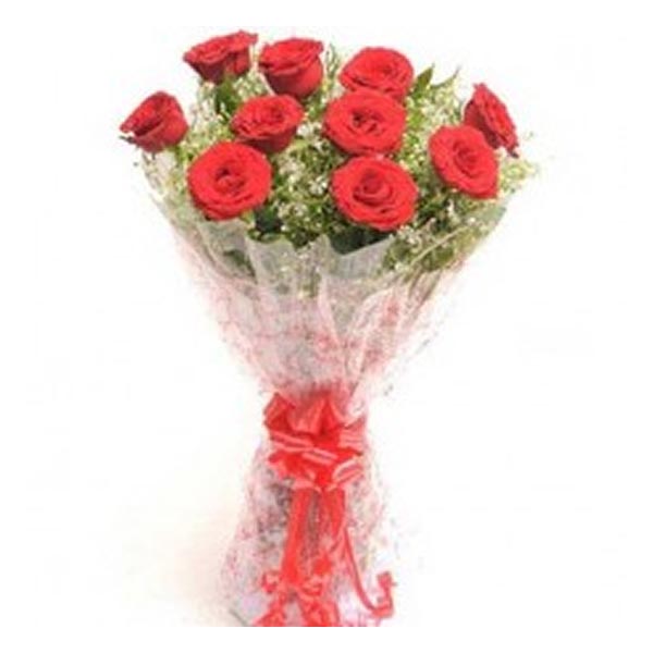 Red roses and seasonal leaves wrapped with cellophane and tied with red ribbon