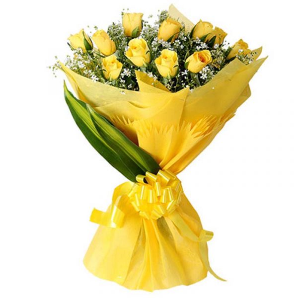 Yellow roses and green leaves wrapped with yellow paper and tied with yellow ribbon